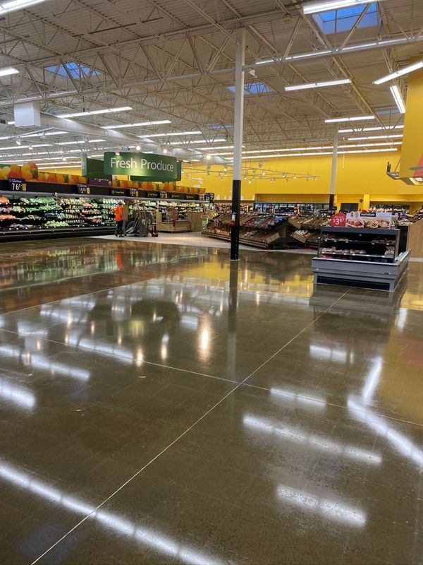The inside of a grocery store with a shiny concrete floor.