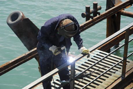 male worker installing metal handrails