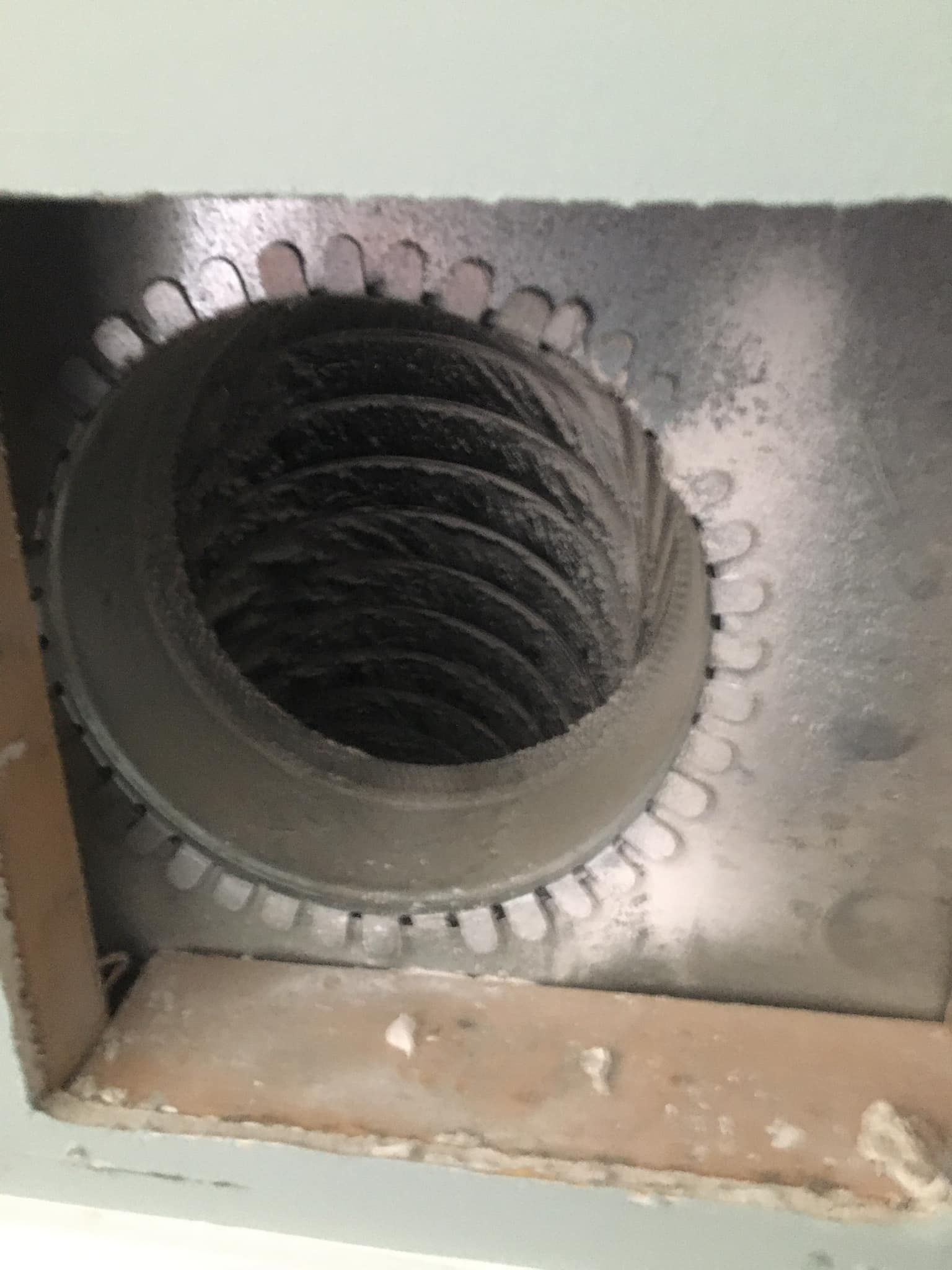 A close up of a duct with a hole in it.