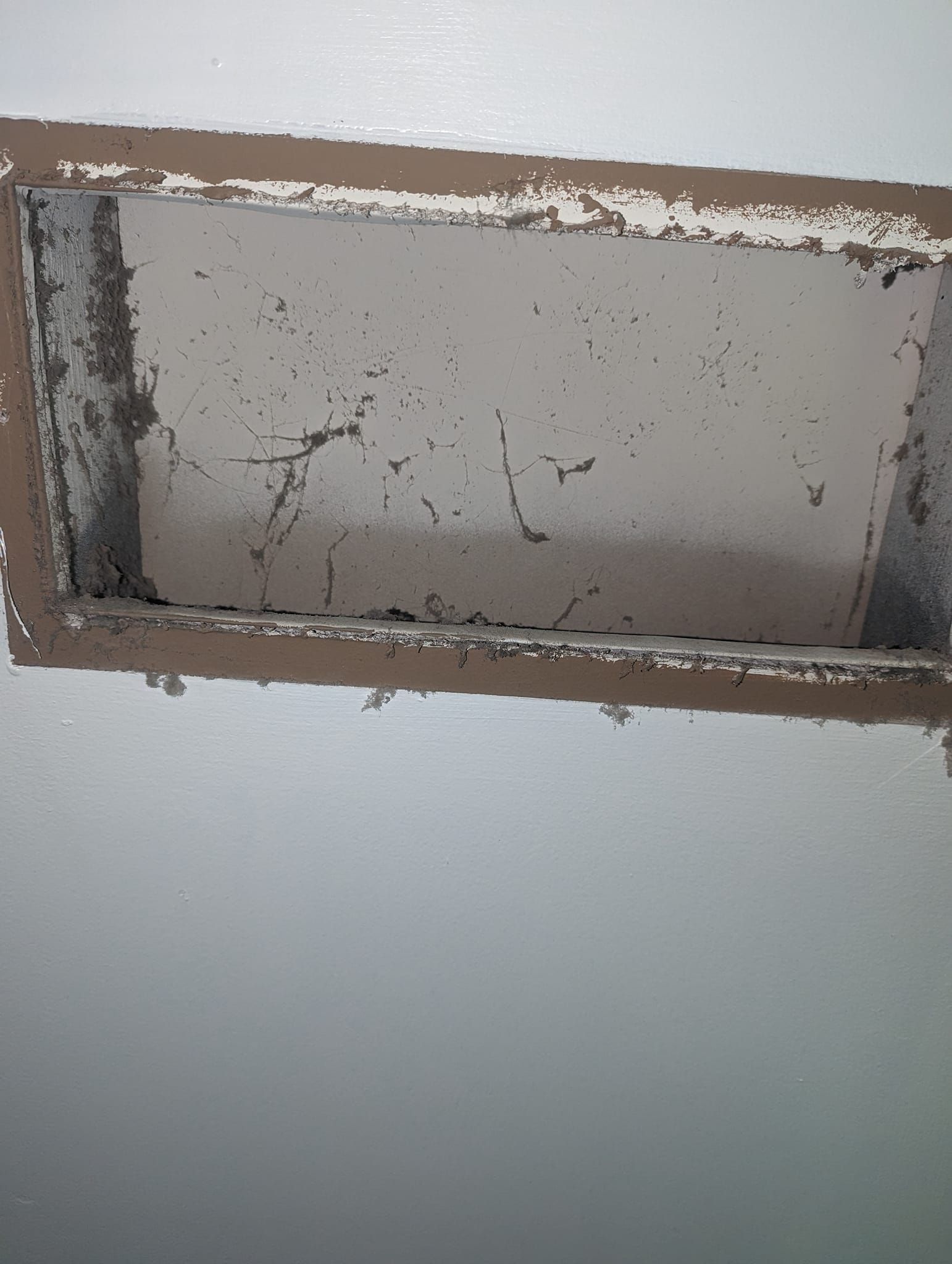 There is a hole in the wall that looks like a window.