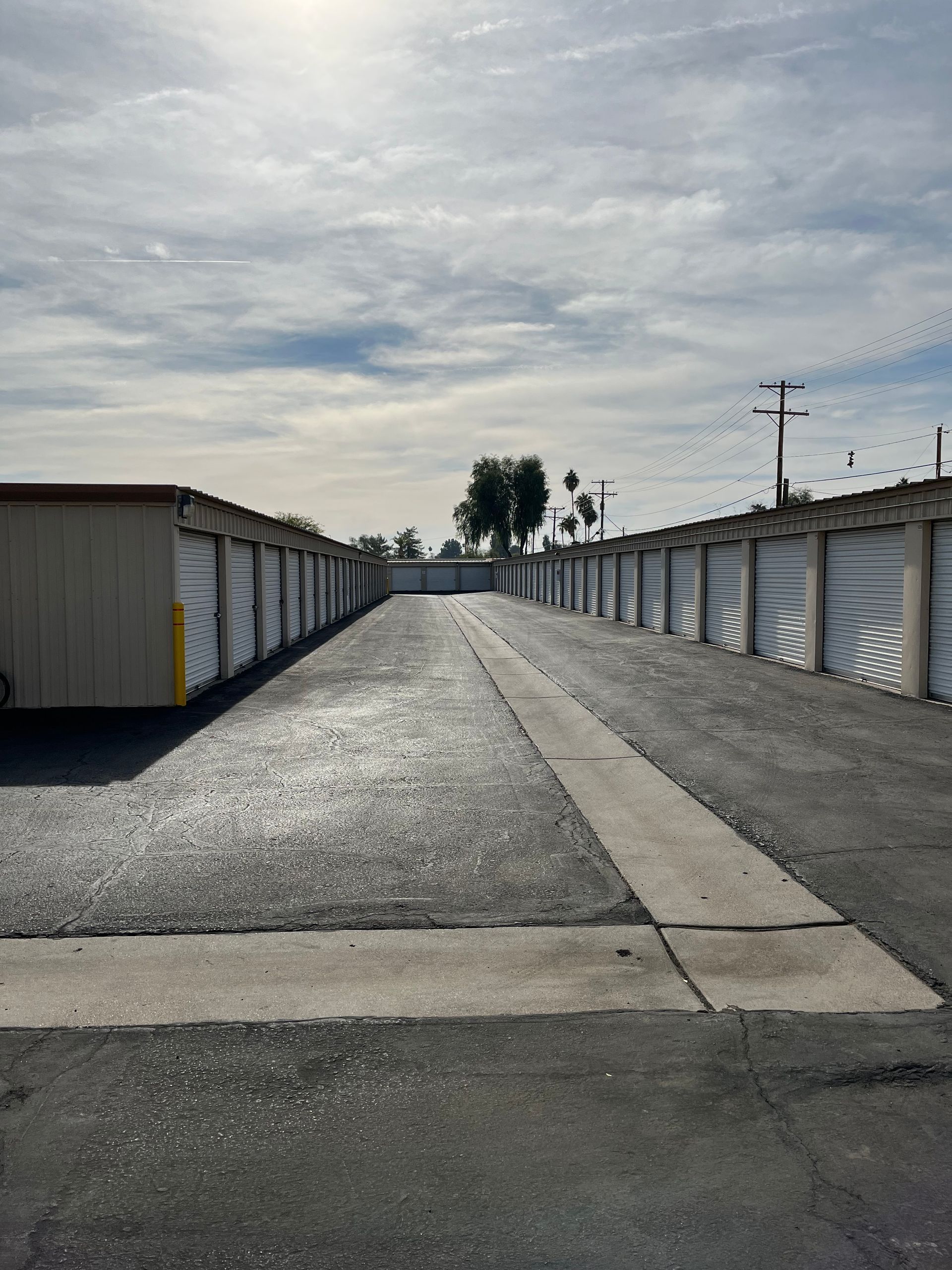 A row of storage units are lined up on the side of a road.
