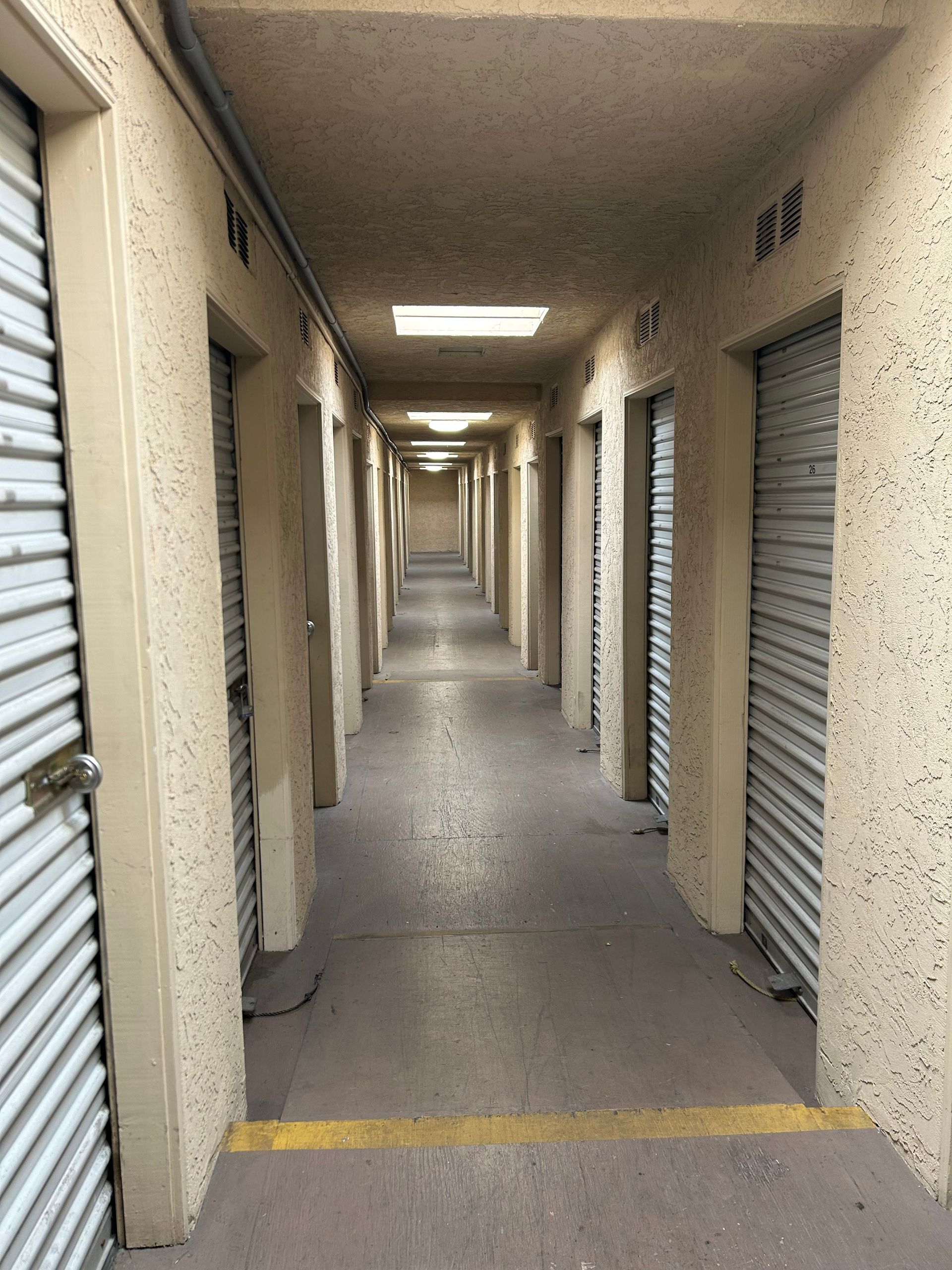 A long hallway filled with lots of storage units.