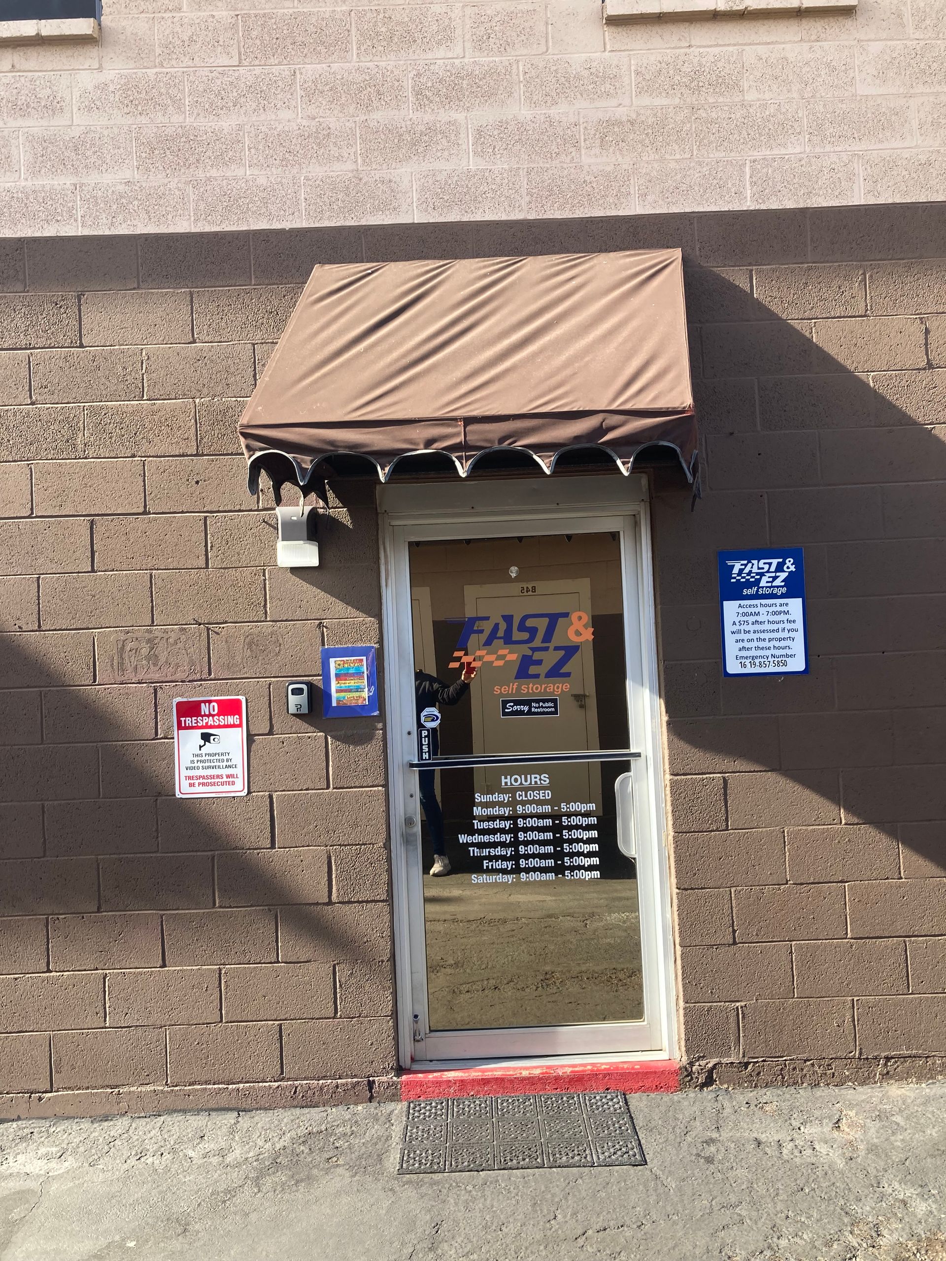 A brick building with a door that says east ez on it