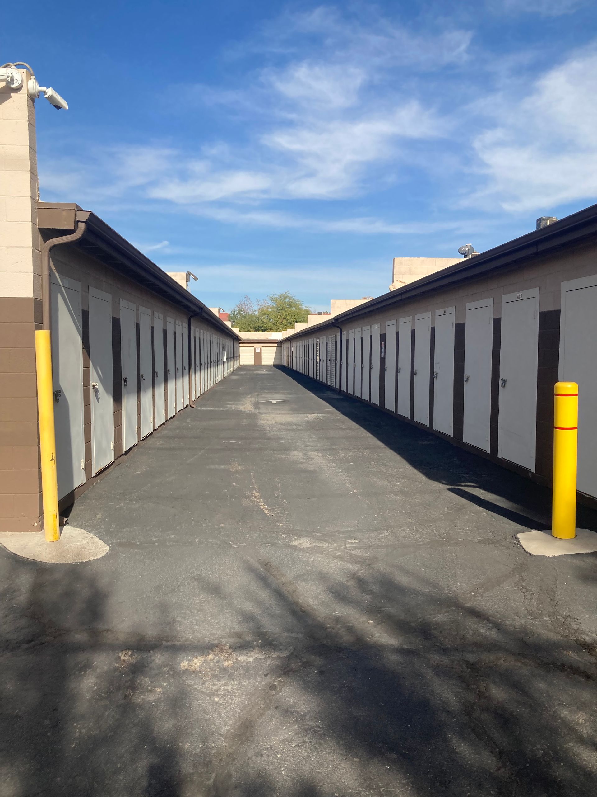 A row of storage units with a yellow pole in the middle