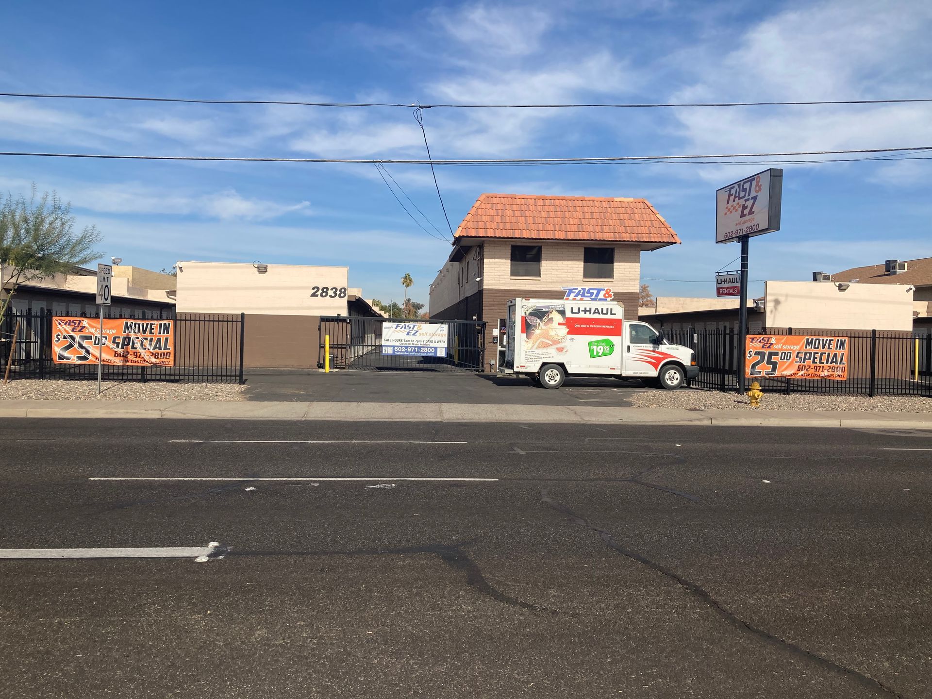 A white van is parked in front of a motel