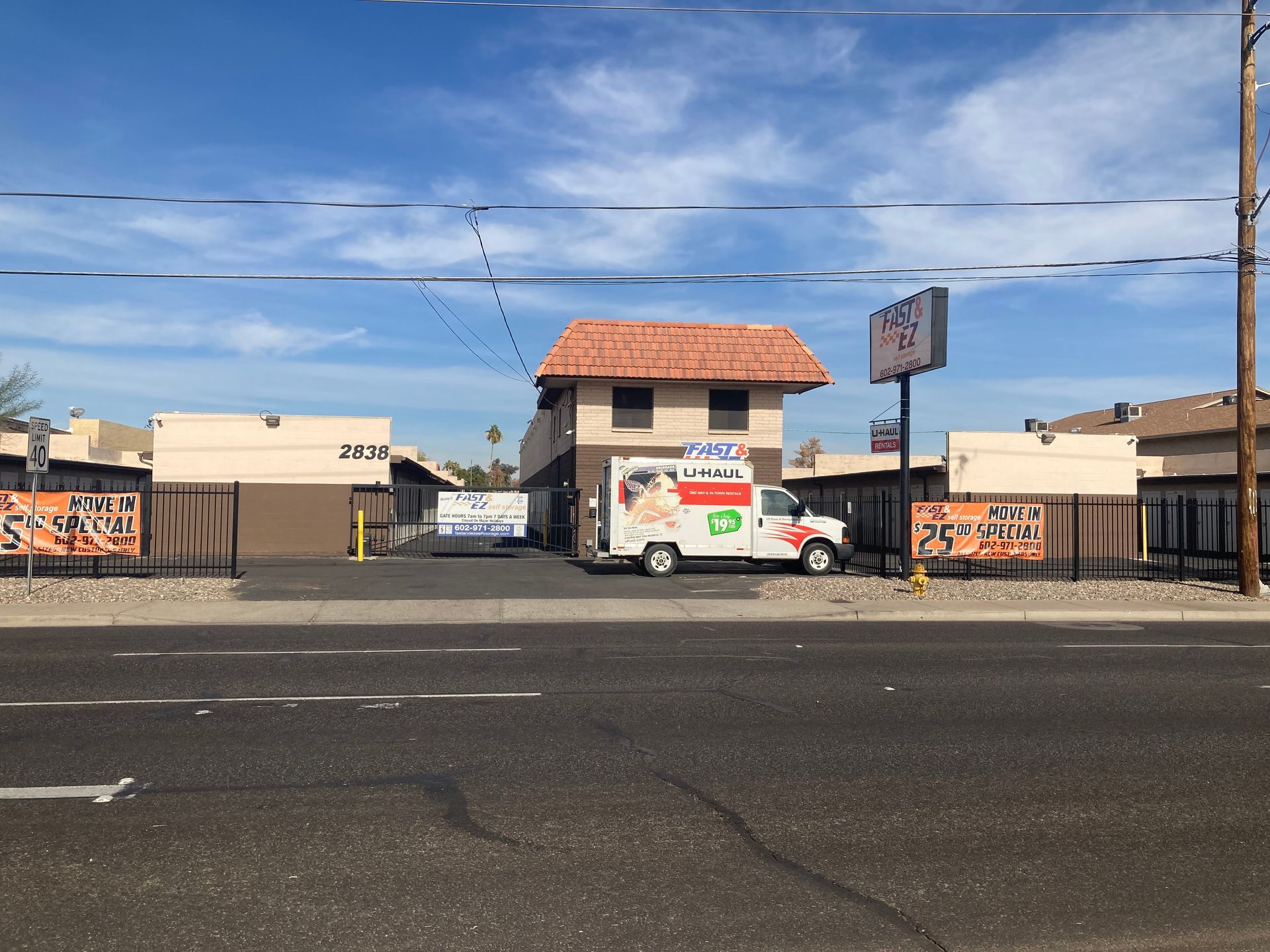 A white van is parked in front of a motel