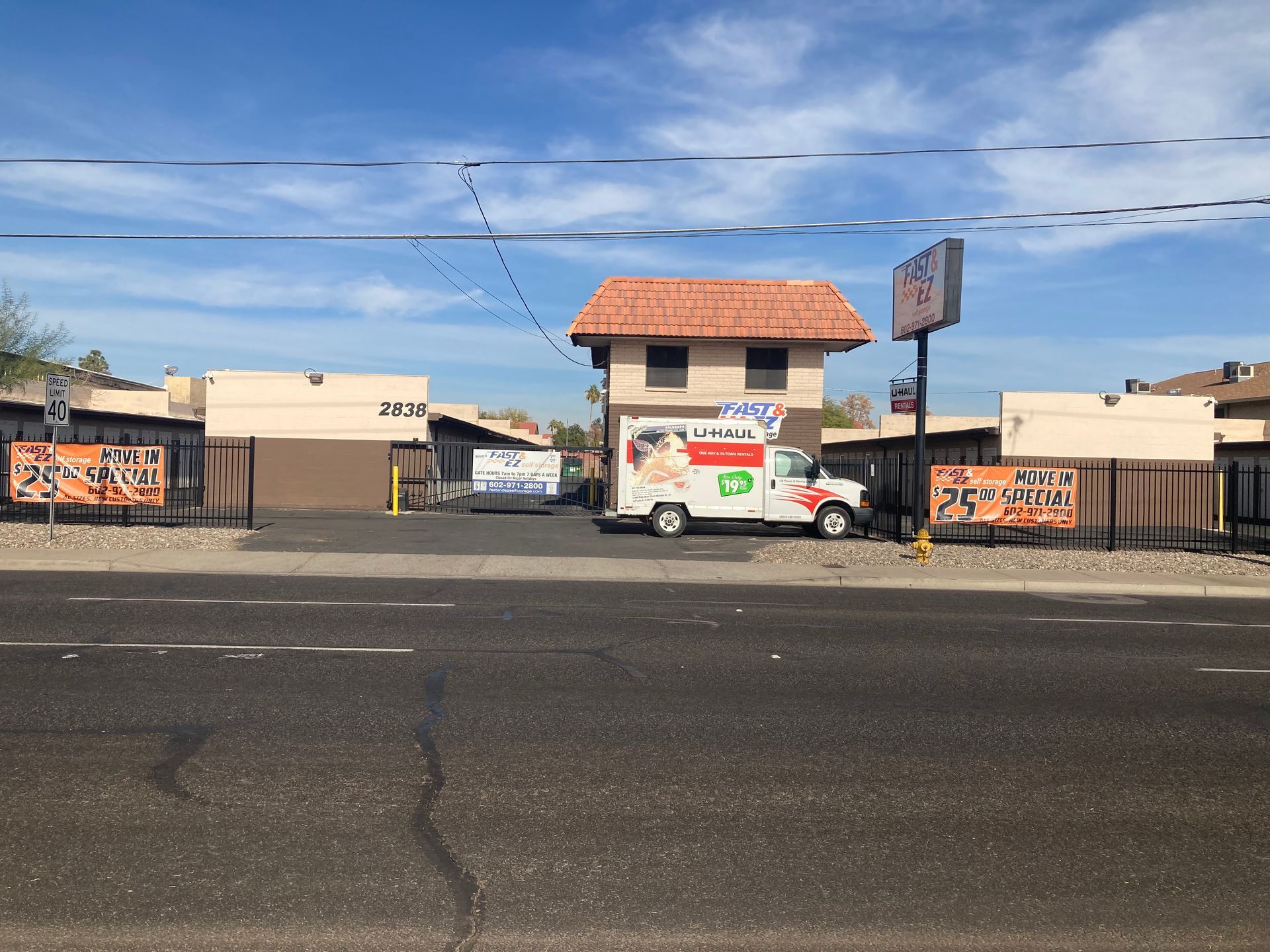 A white van is parked in front of a building
