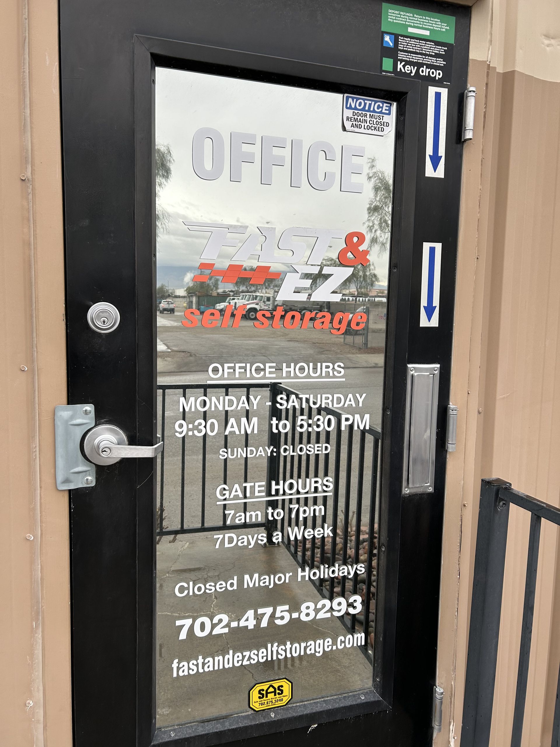 A black door with a sign on it that says office hours