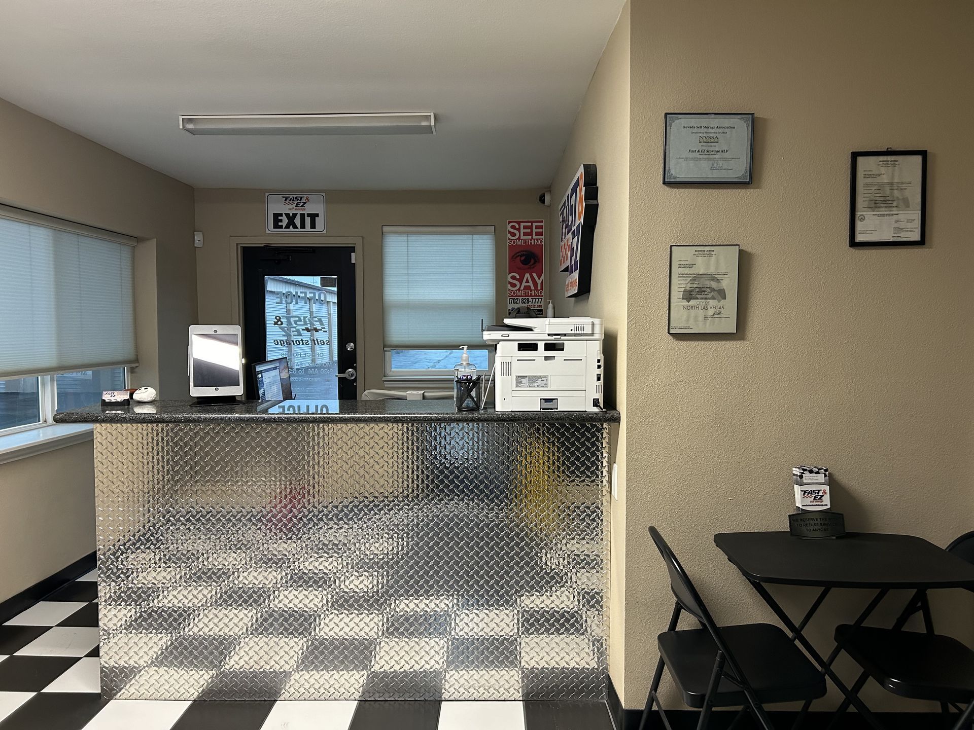 A room with a checkered floor and a sign that says exit