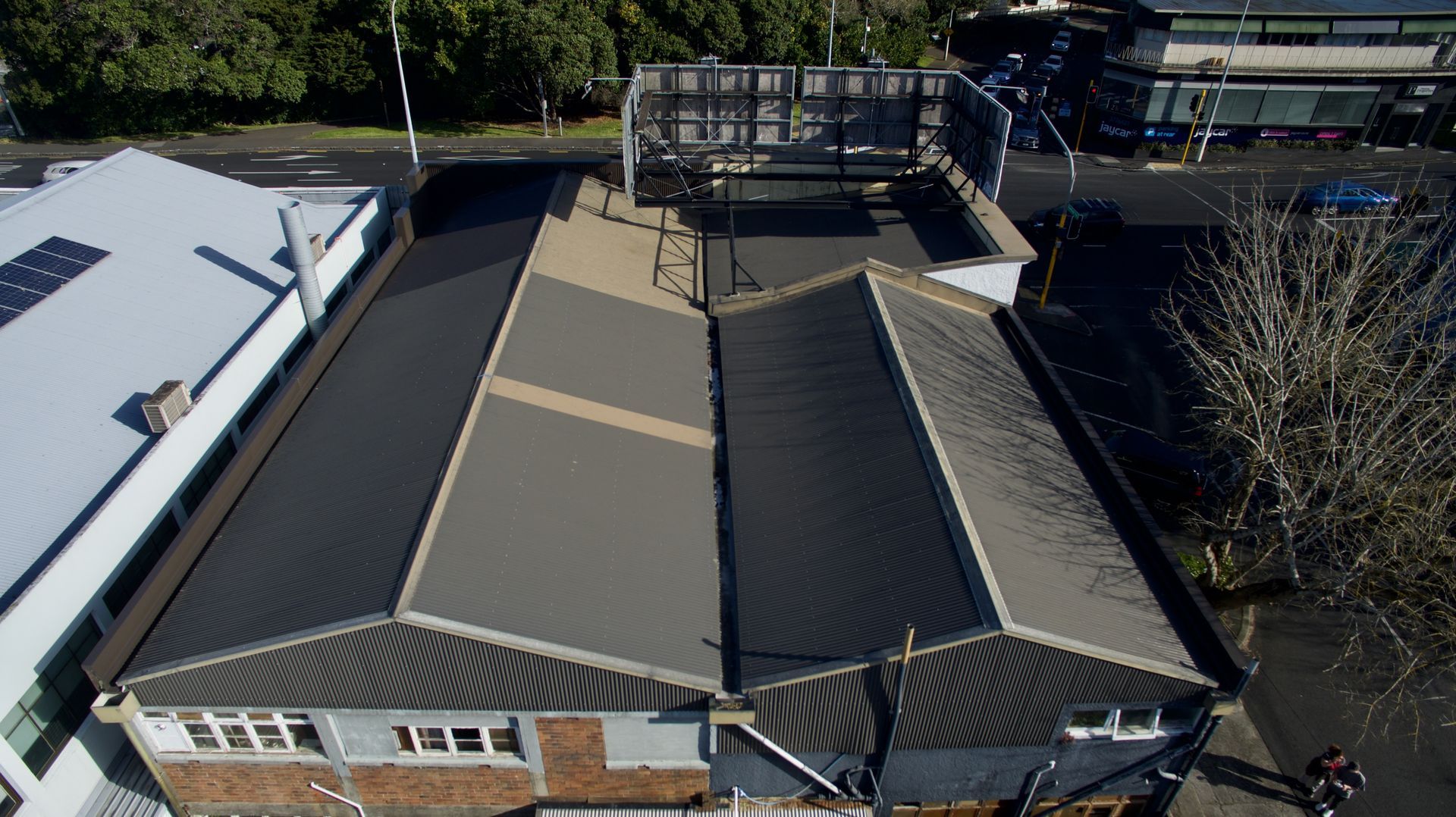 A White House with a Gray Roof and a Blue Sky — Auckland, NZ — Pro Roofing