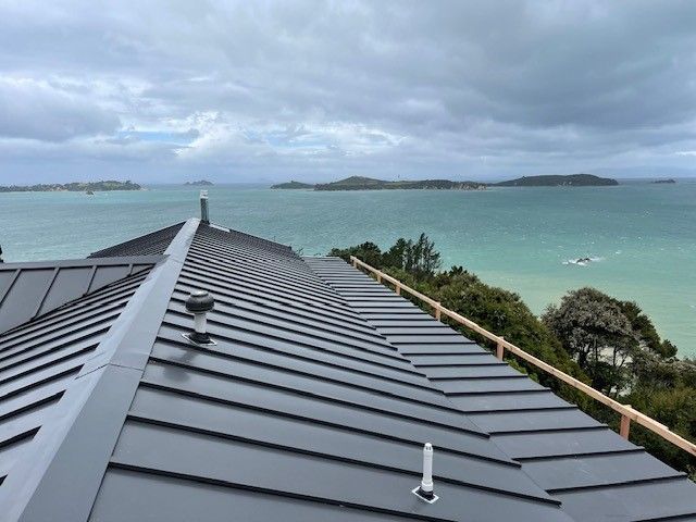 A Row of Houses with Cars Parked in Front of Them — Auckland, NZ — Pro Roofing