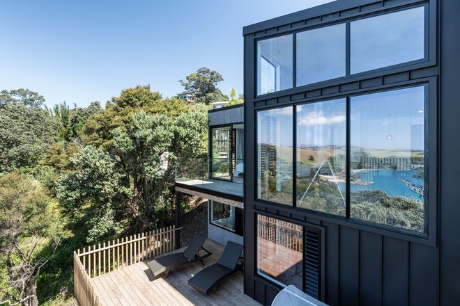 A Large House with a Brown Garage Doors — Auckland, NZ — Pro Roofing