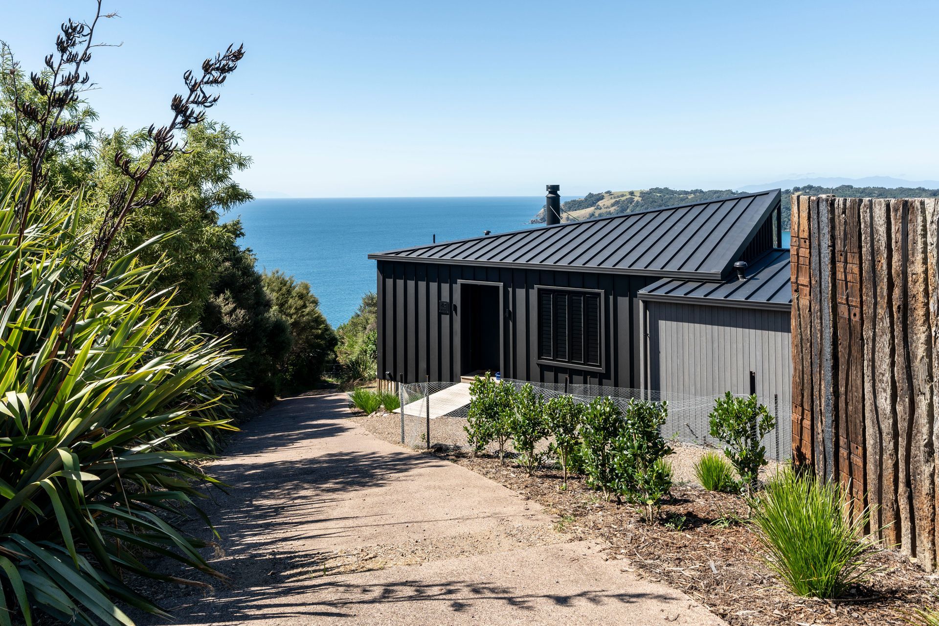 A Path Leading to a Black House with a View of the Ocean — Auckland, NZ — Pro Roofing