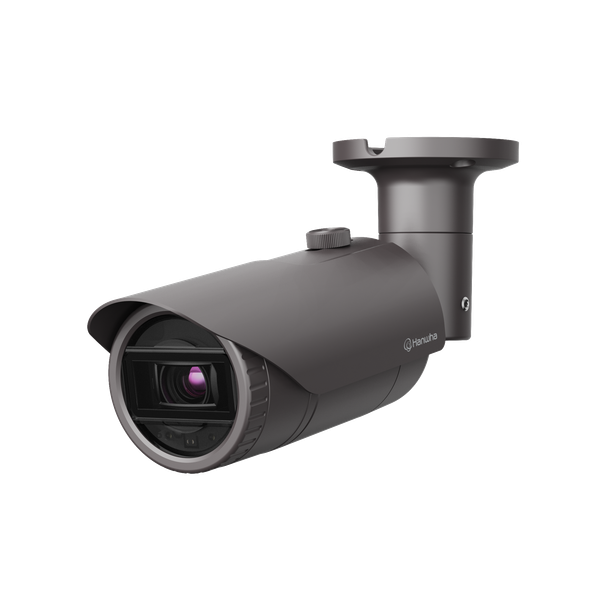Dark gray security camera, mounted on a wall, with a lens and protective hood.