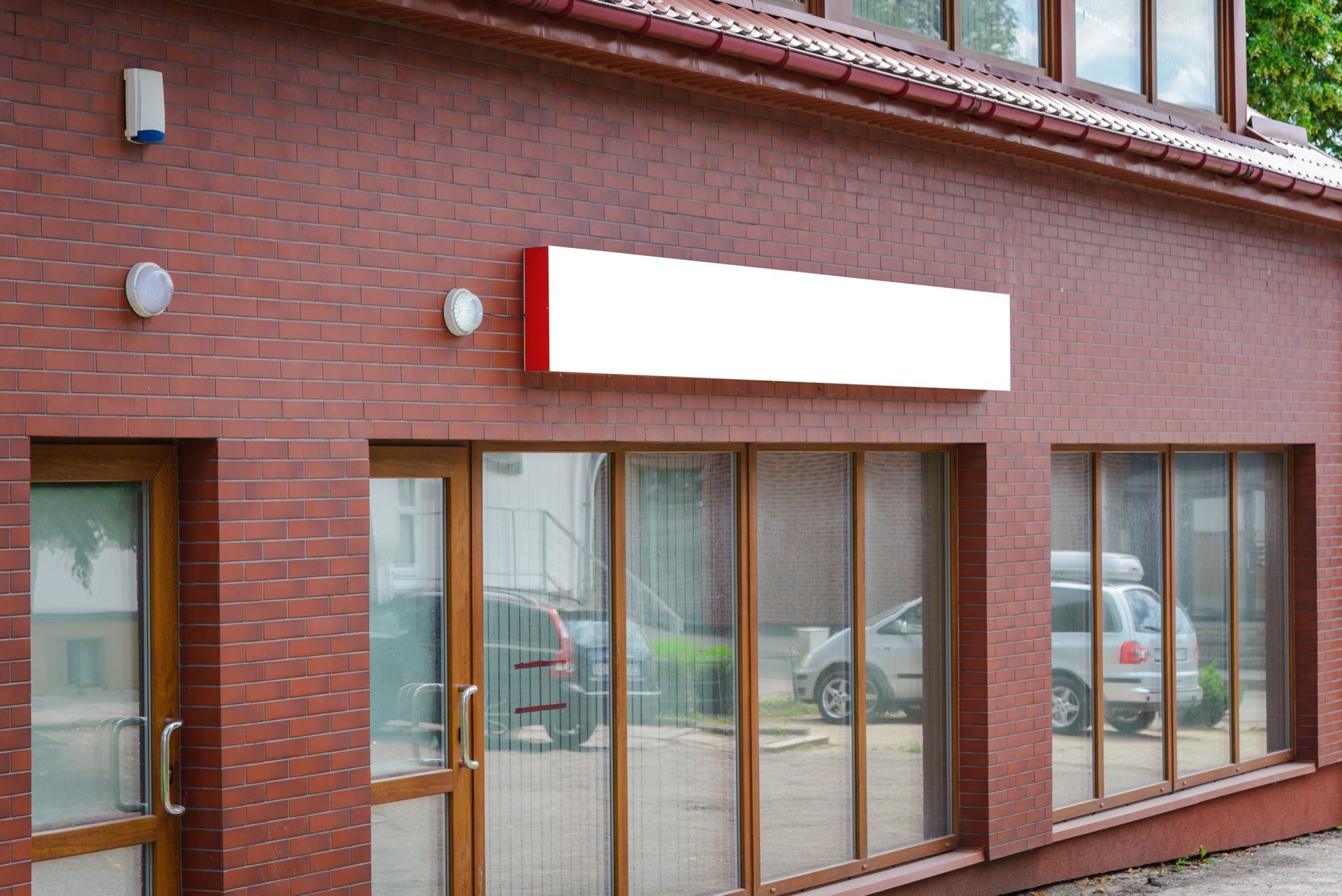 A red brick building with a white sign on the side of it.