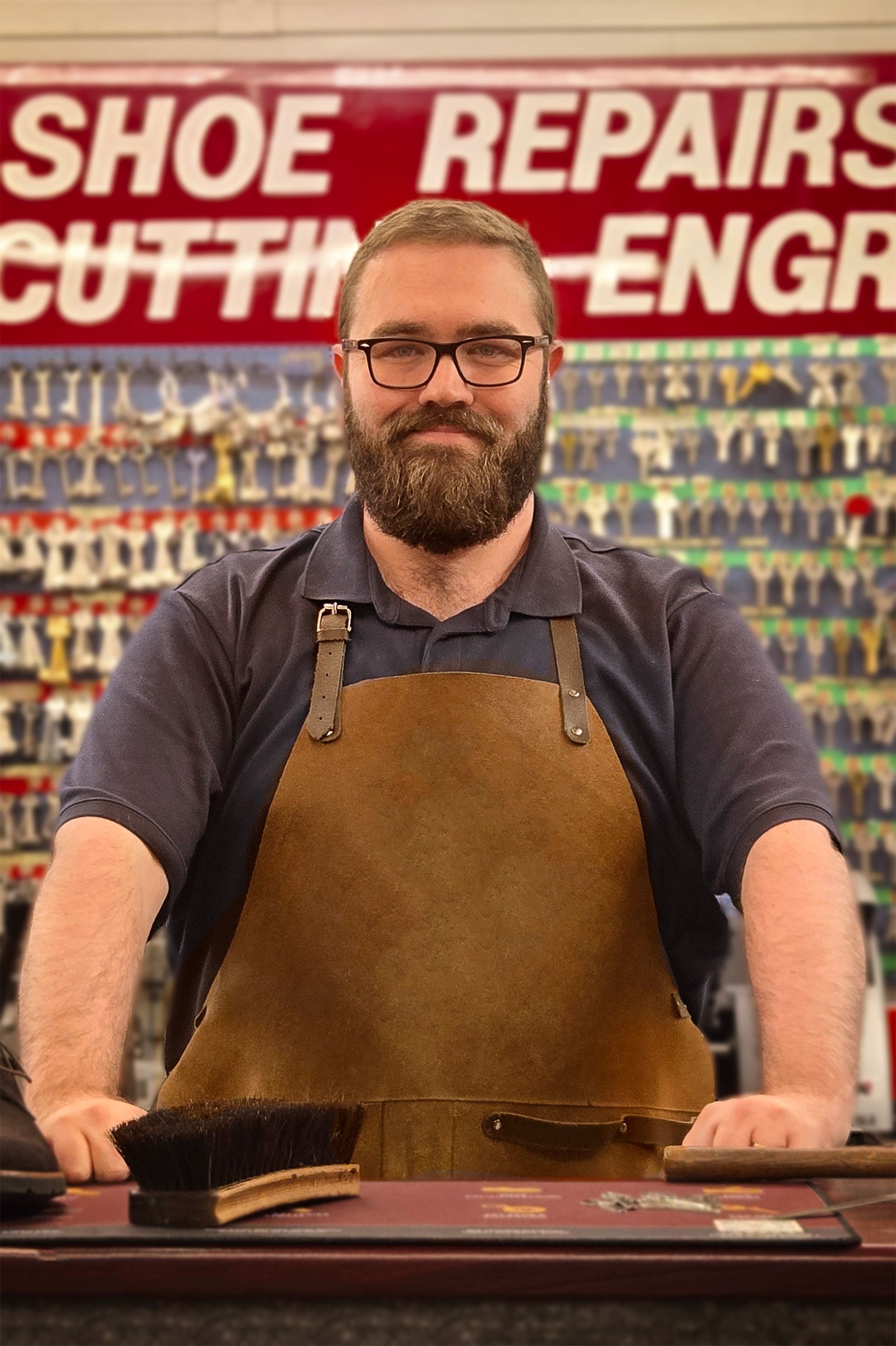Local craftsman at Sole to Sole working behind the counter.