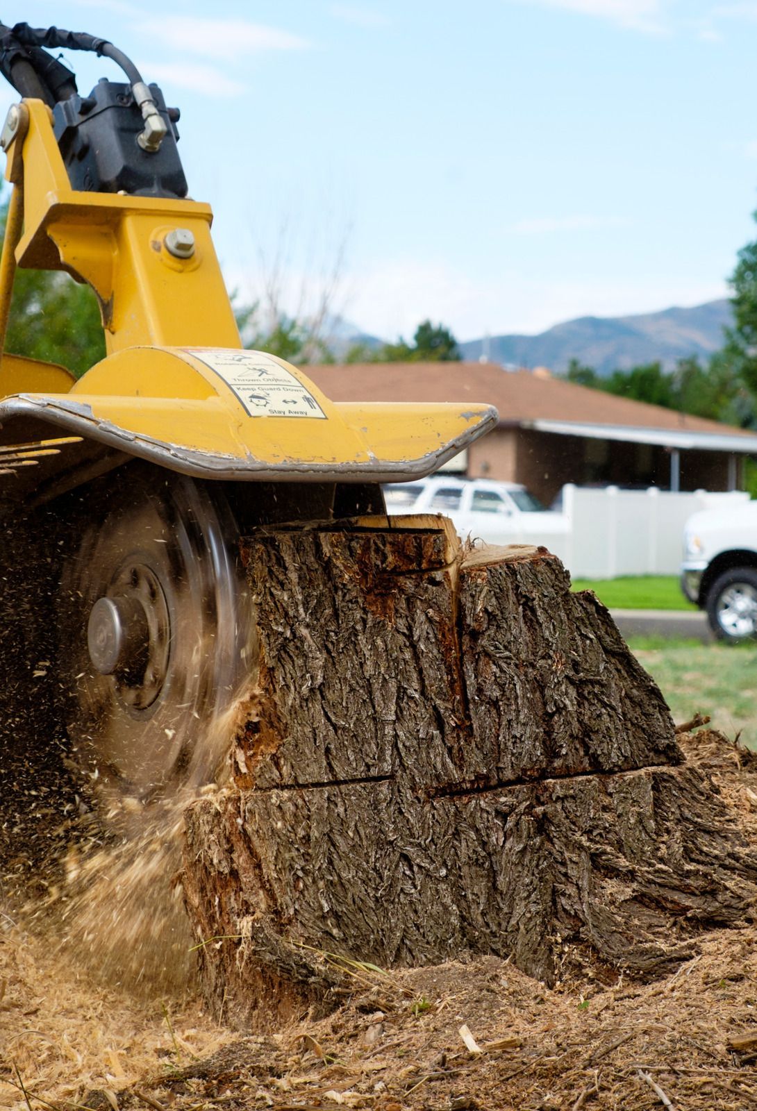 A tree stump is being removed by a machine.