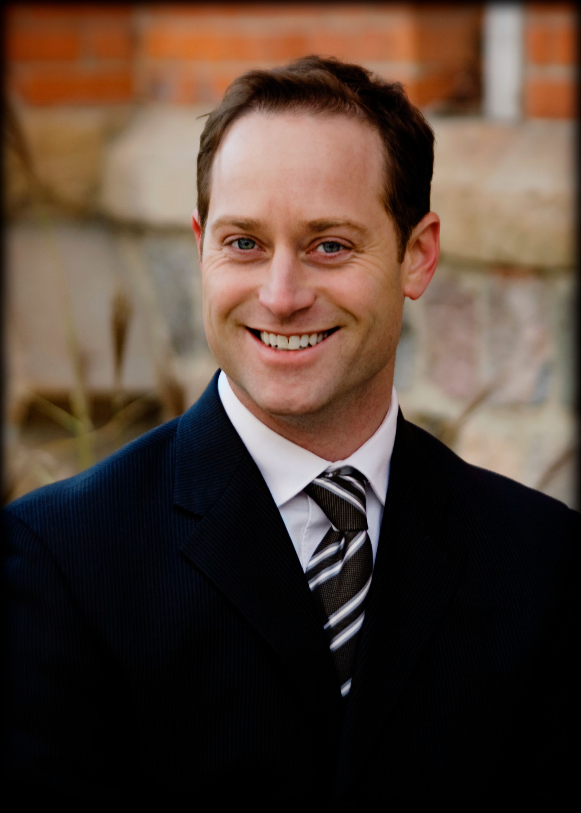 Brett Huffmaster posing for his bio photo for The Huffmaster Group website.