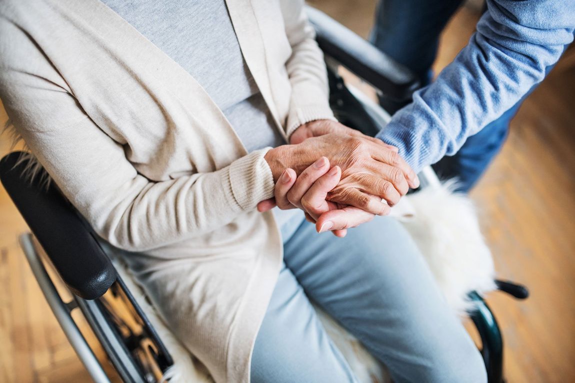 Caregiver holding old woman's hands — High Ridge, MO — Heart & Homes Care LLC