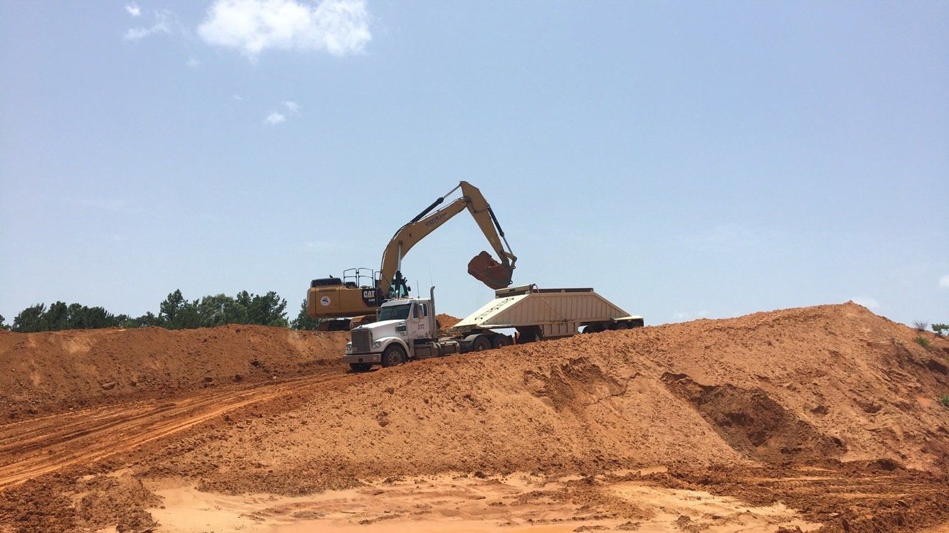 Backhoe And Trailer Truck For Subgrade Preparation — Judson, TX — W.R. Welborn & Son Inc.