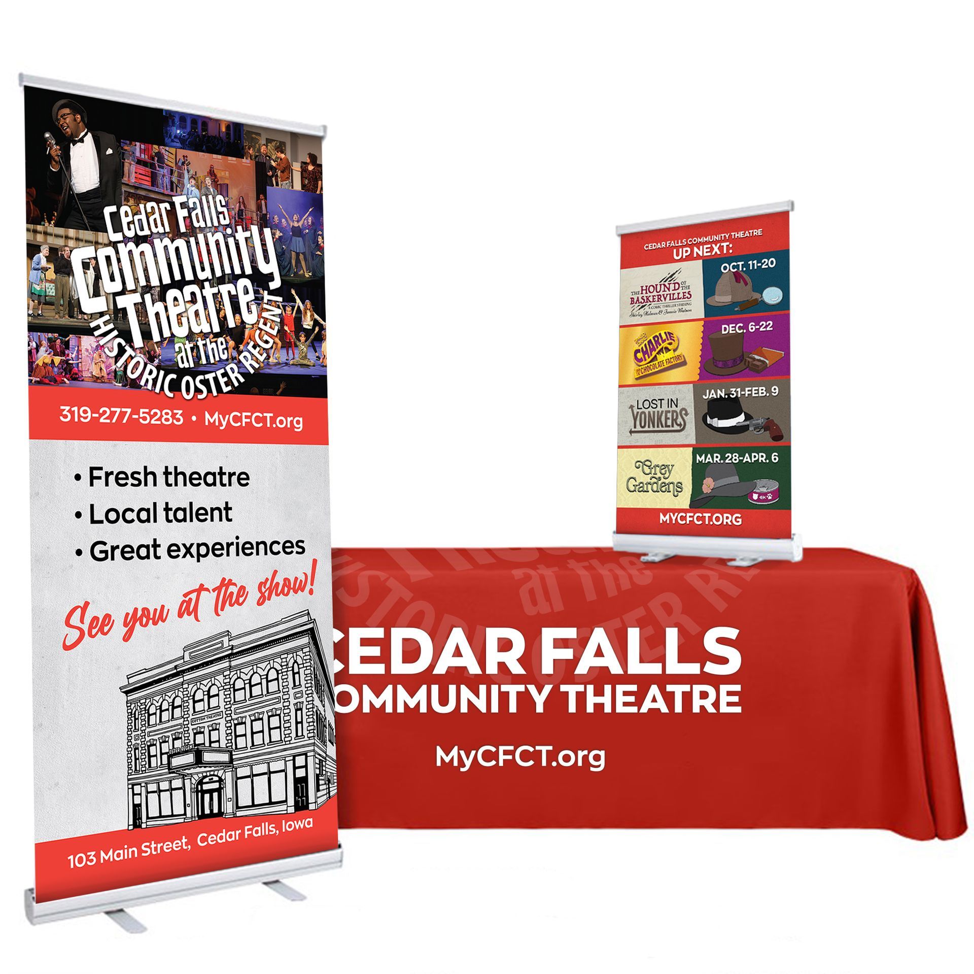 A table with a red table cloth and a banner for the cedar falls community theatre