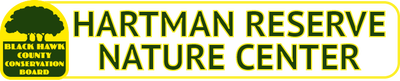 Hartman reserve nature center logo with a tree on it