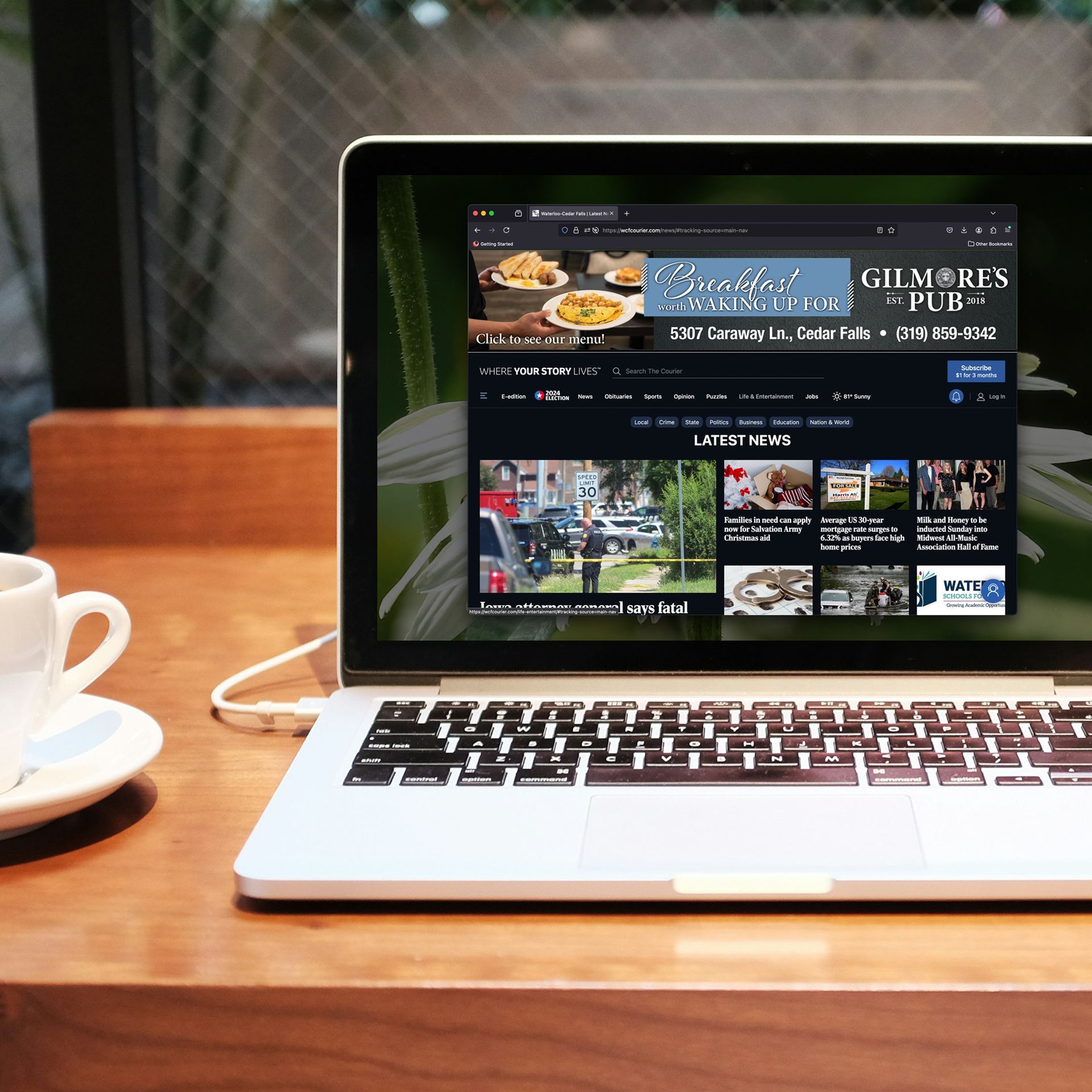 A laptop is open to a page that says gilmores pub