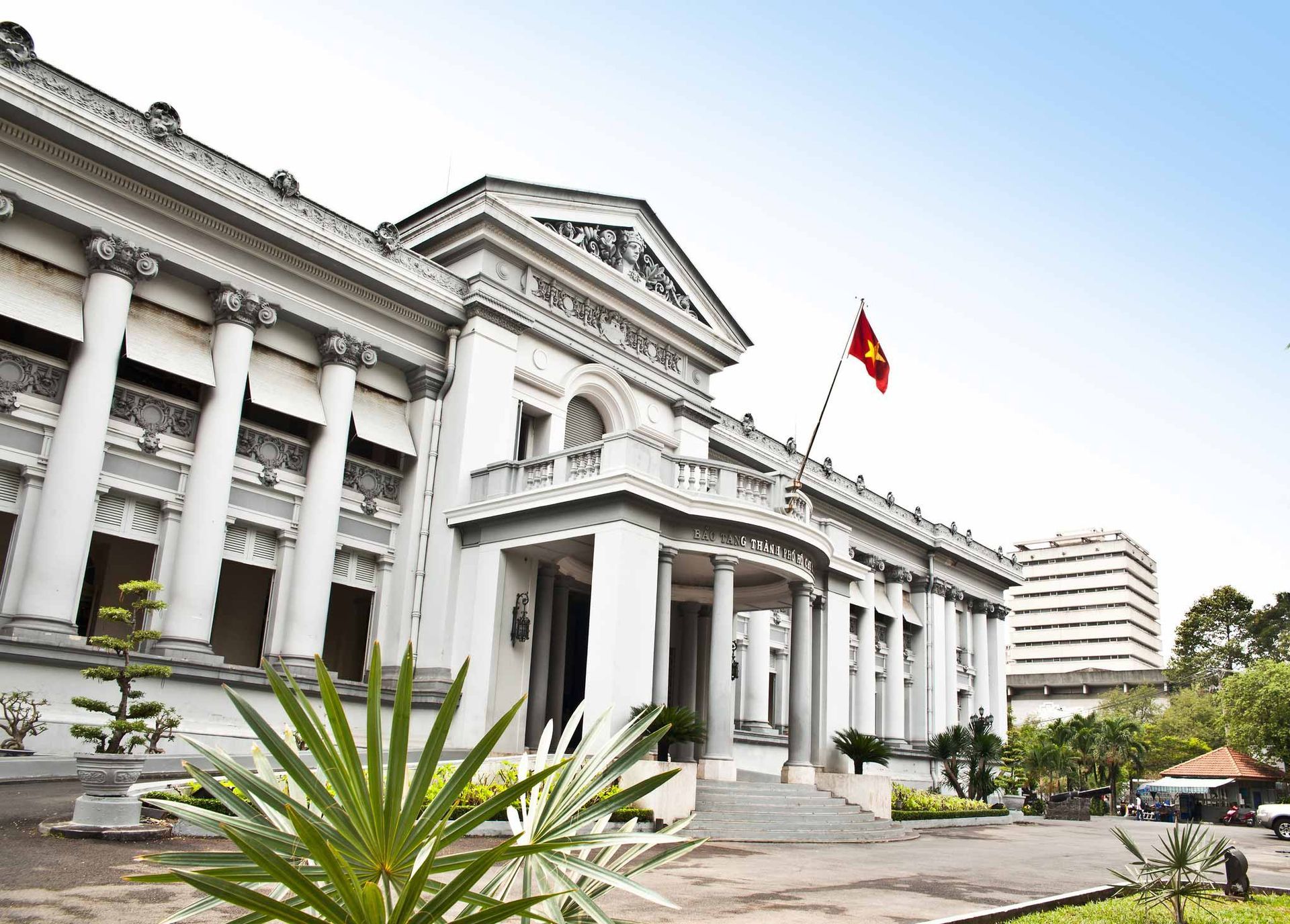 A large white building with a flag in front of it