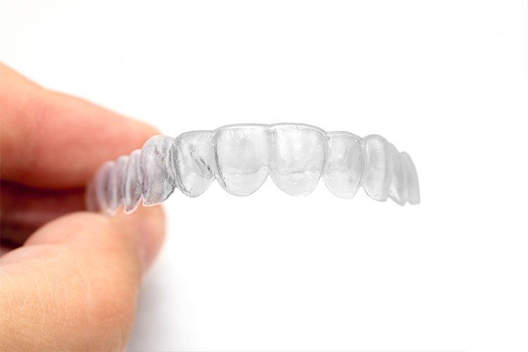 hand holding invisalign tray