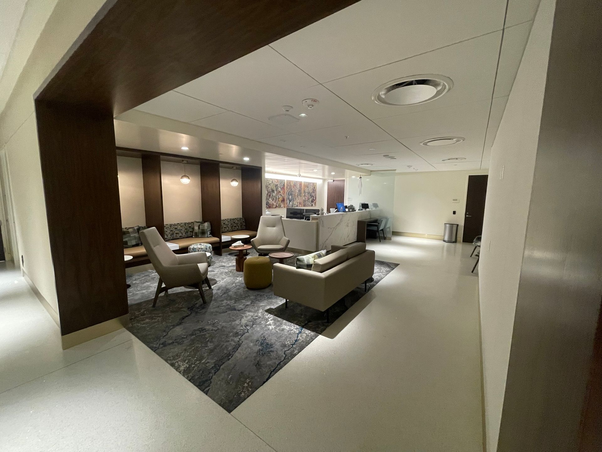 A living room with a couch , chairs , and a table.