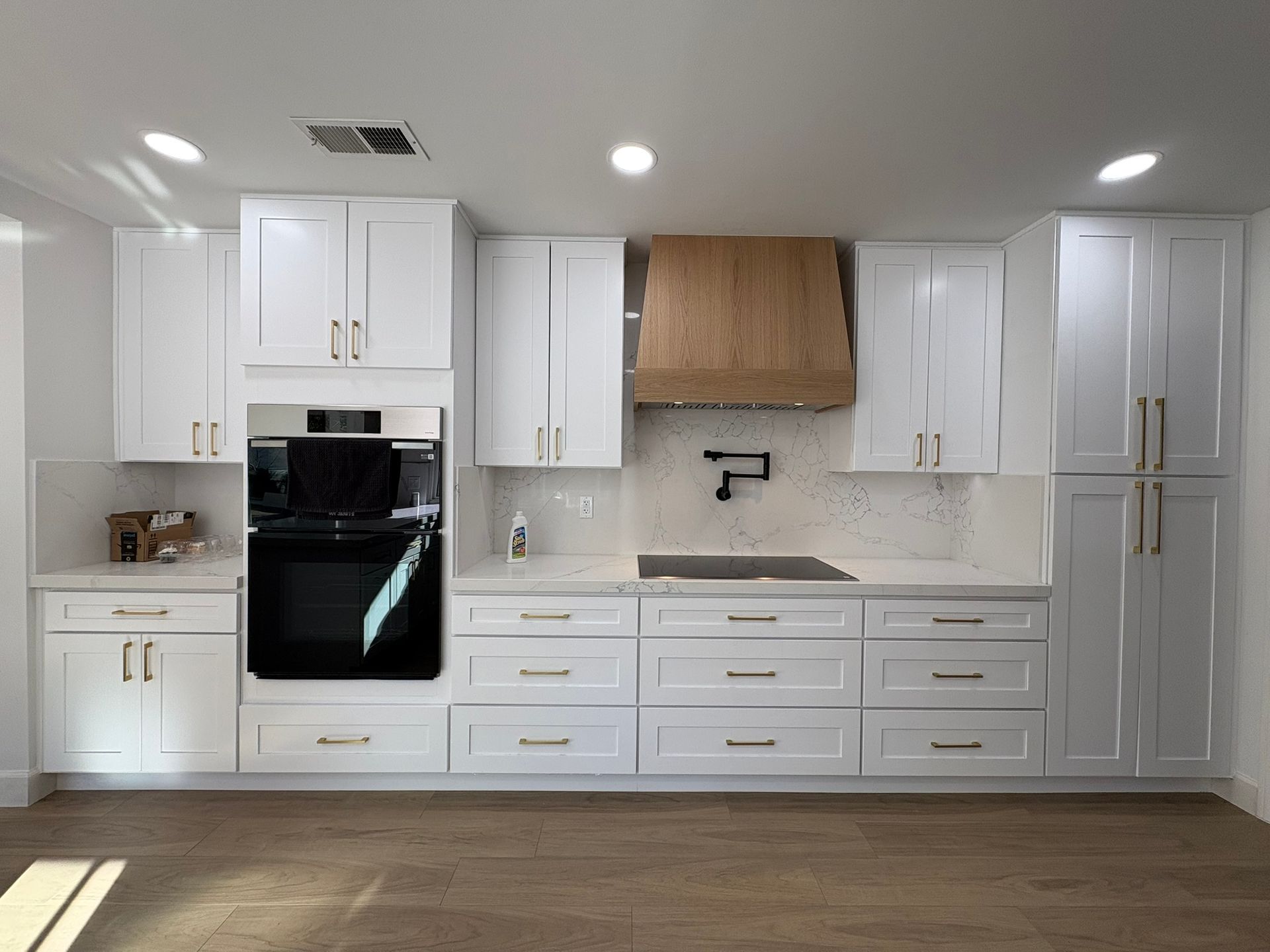 A kitchen with white cabinets and stainless steel appliances