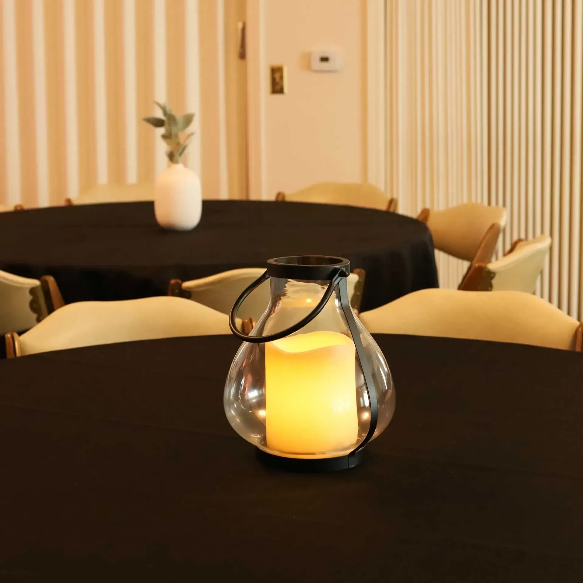 A living room with a couch , chairs and a table