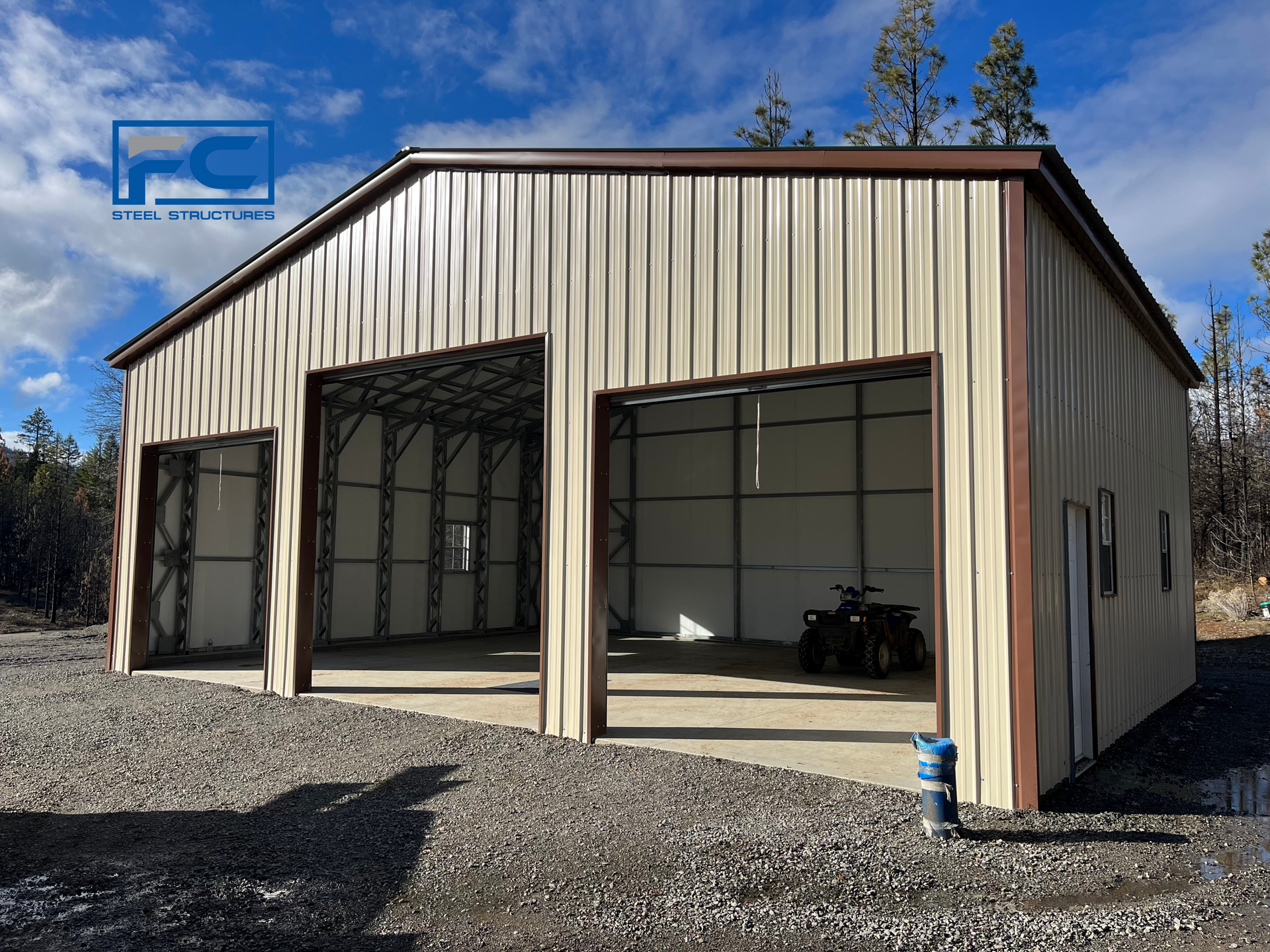 A metal building with a atv parked inside of it