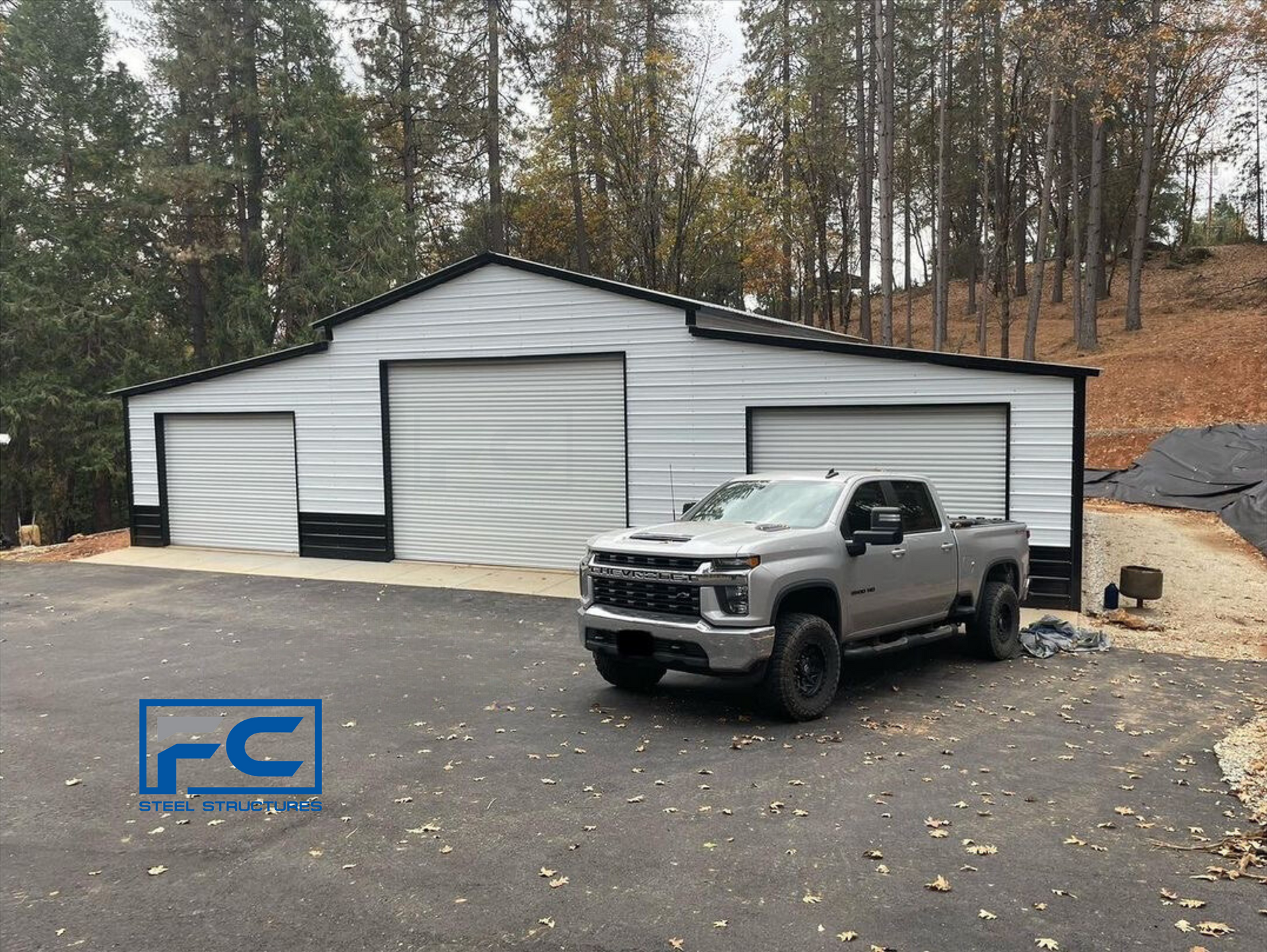 A truck is parked in front of a garage.
