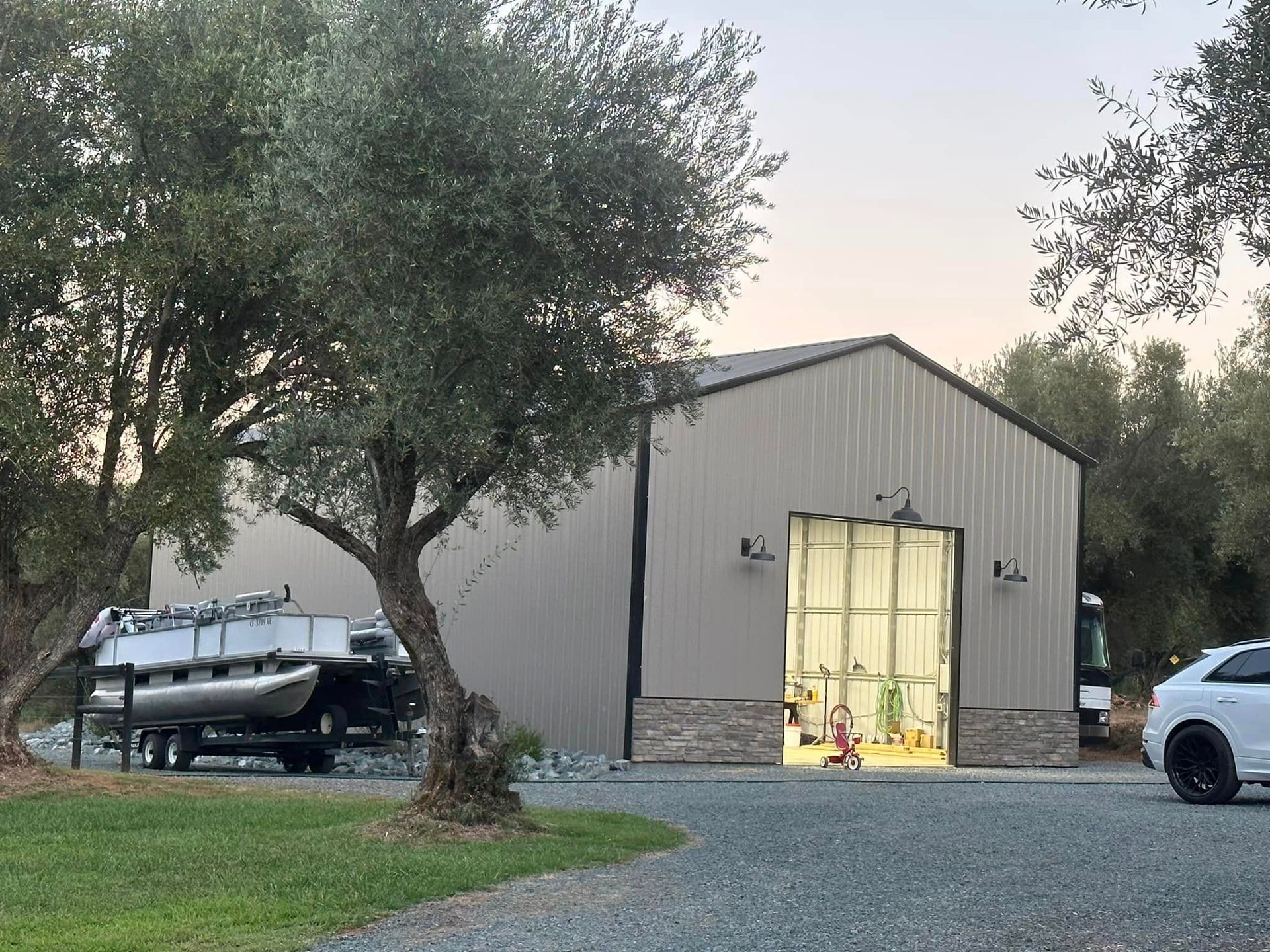 A boat is parked in front of a building with a car parked in front of it.
