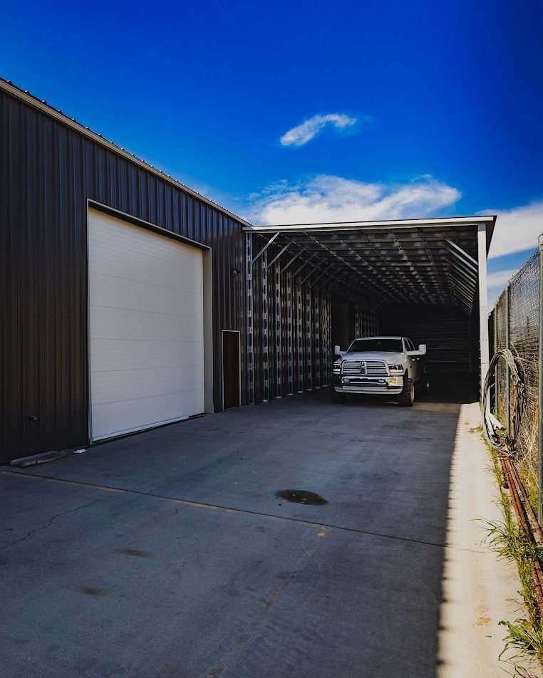 A truck is parked under a covered garage door