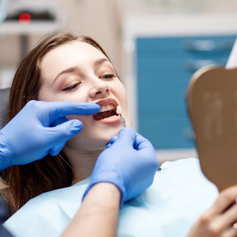 volto di una donna durante una visita dentistica