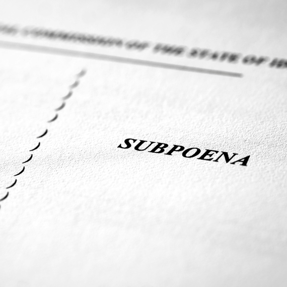 The word subpoena is on a piece of paper