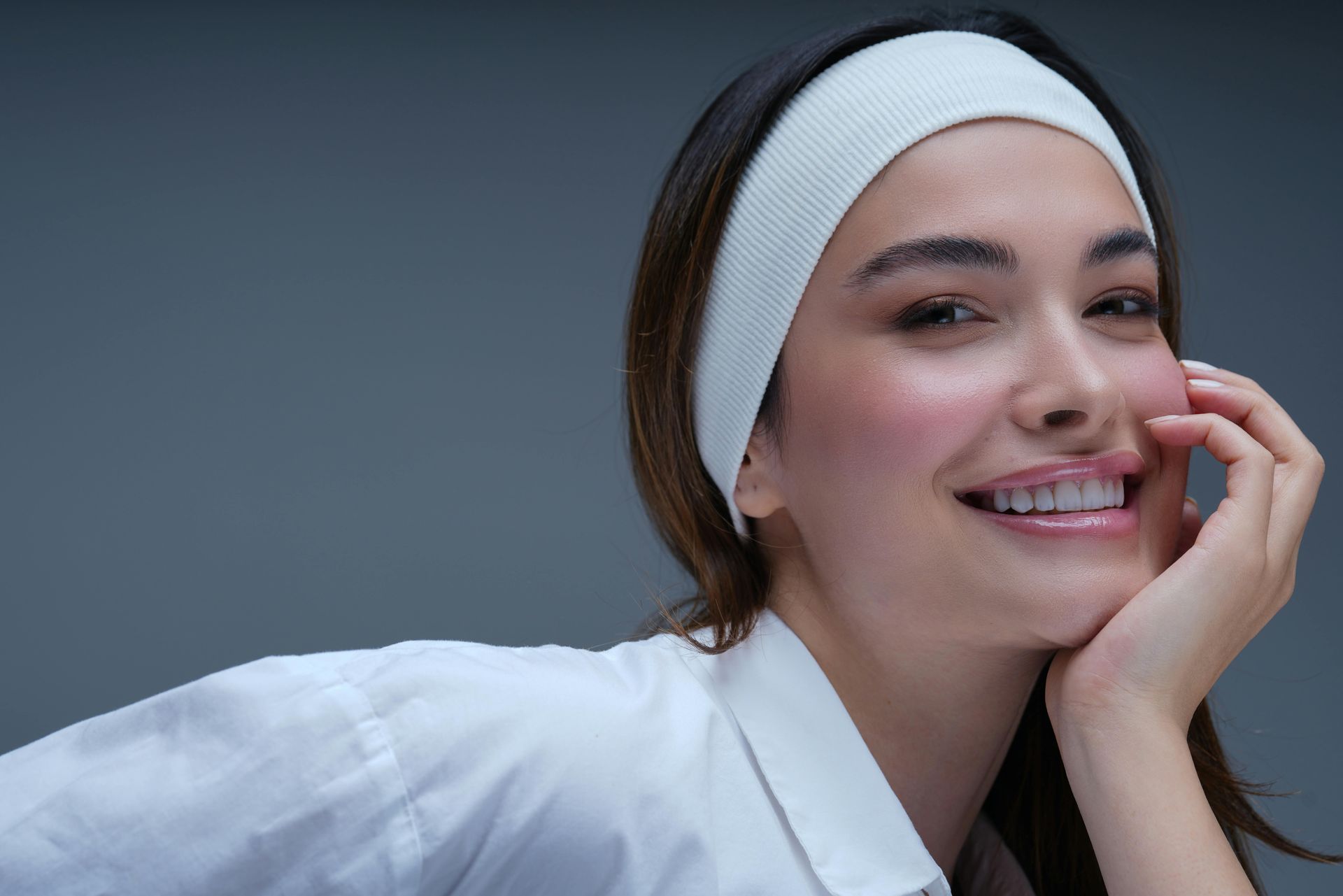 A woman with flawless skin smiling