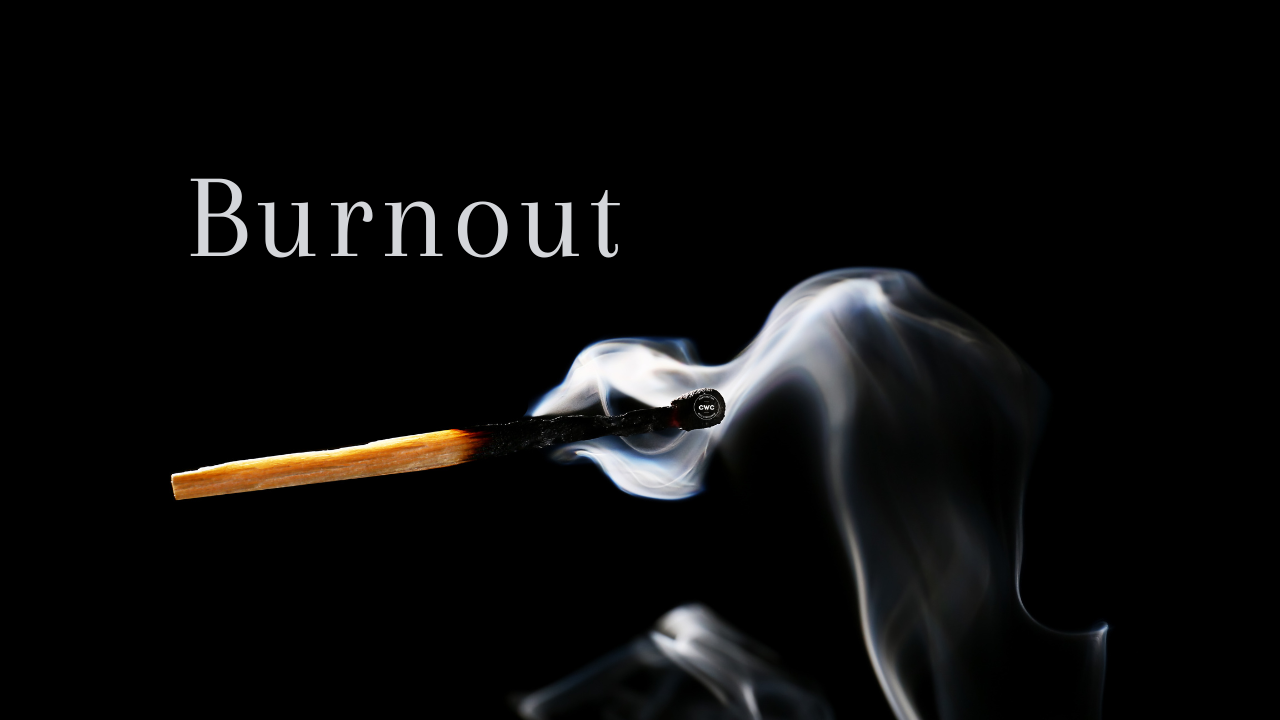A smoking burnt out match against a black background, with the word 'burnout' 