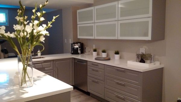 A kitchen with a vase of flowers on the counter