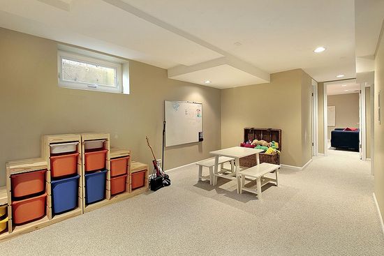 A basement with a table and chairs in it