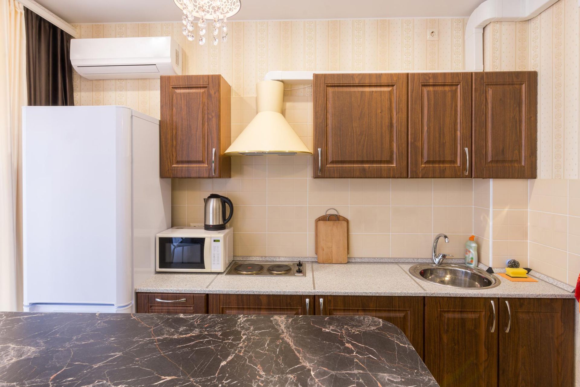 A kitchen with wooden cabinets and a white refrigerator