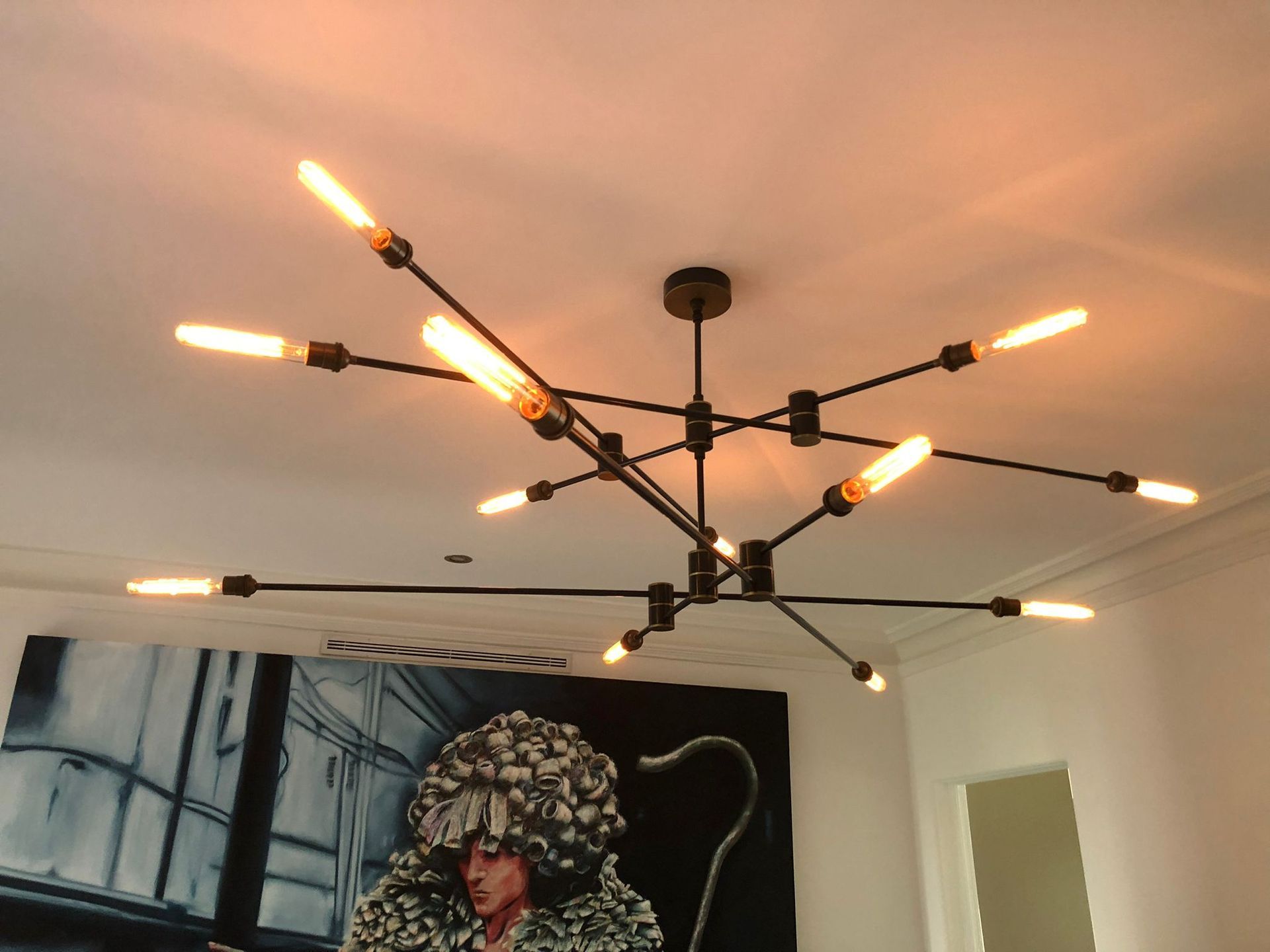 A chandelier is hanging from the ceiling in a room