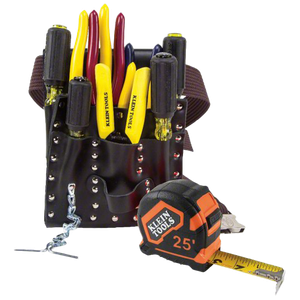 A klein tools tape measure sits next to a tool belt