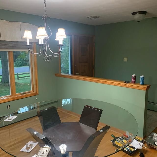 A dining room with a glass table and chairs