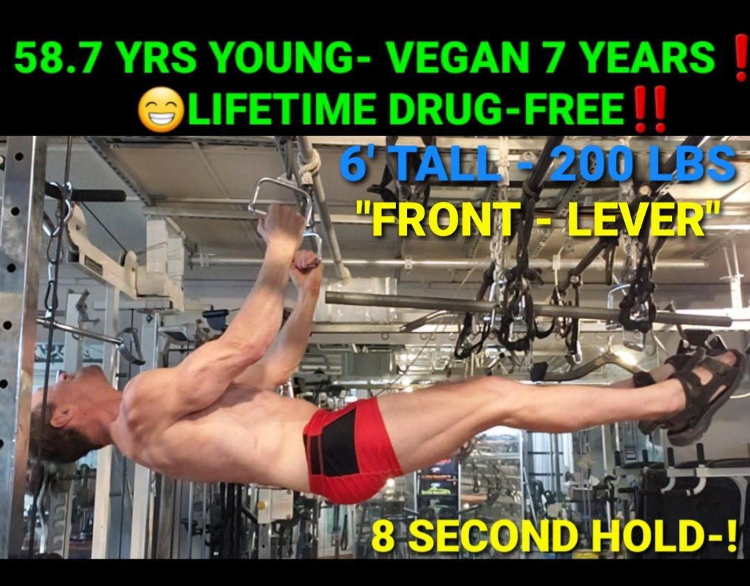 A young man is doing a pull up in a gym