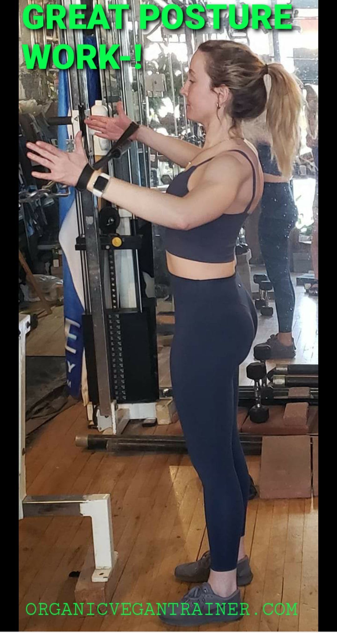 A woman is standing in front of a machine in a gym.
