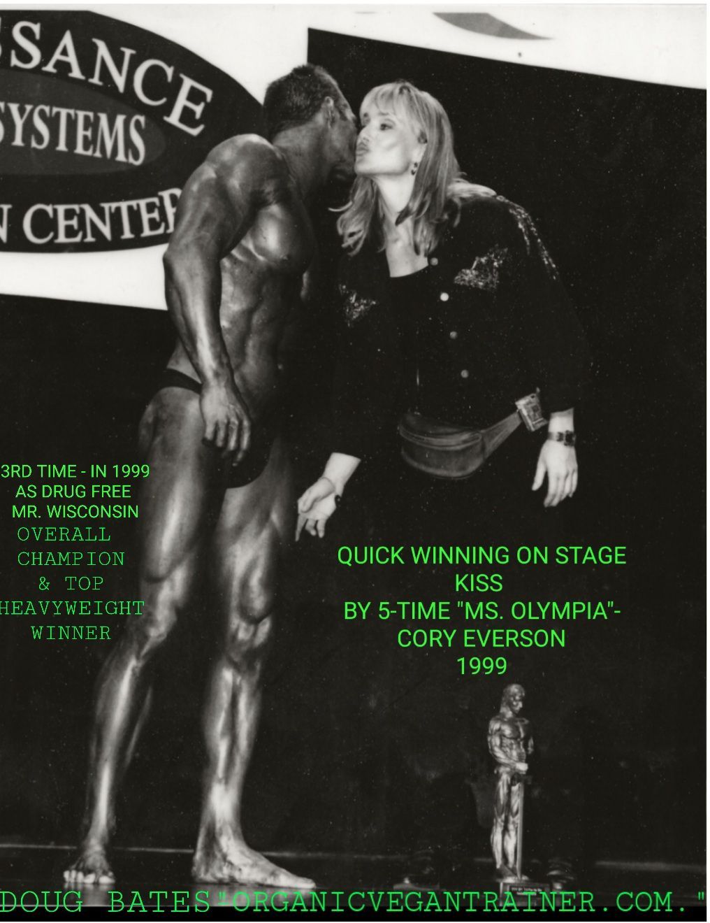 A woman kissing a bodybuilder in front of a sign that says sance systems center