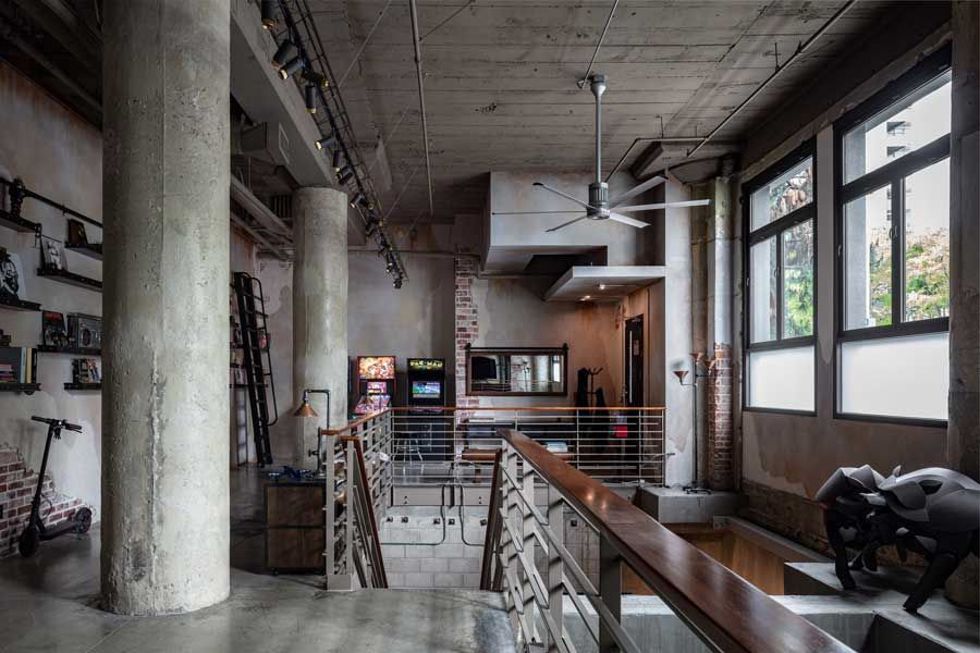 A large room with a lot of windows and a ceiling fan.